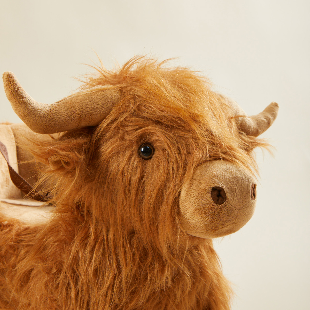 Close-up of Highland cow plush rocker face with long horns